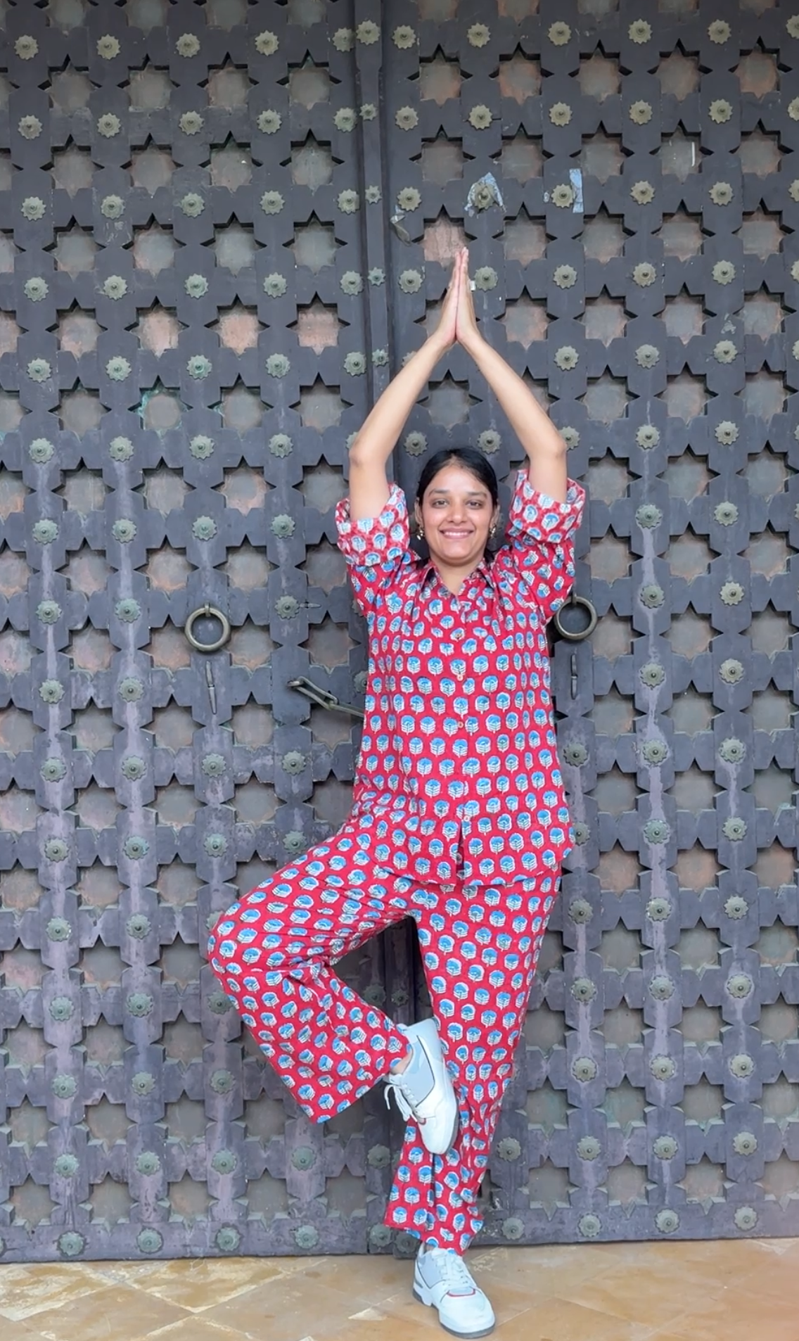 Woman wearing red Rakshita cotton co-ord set with blue floral hand block print