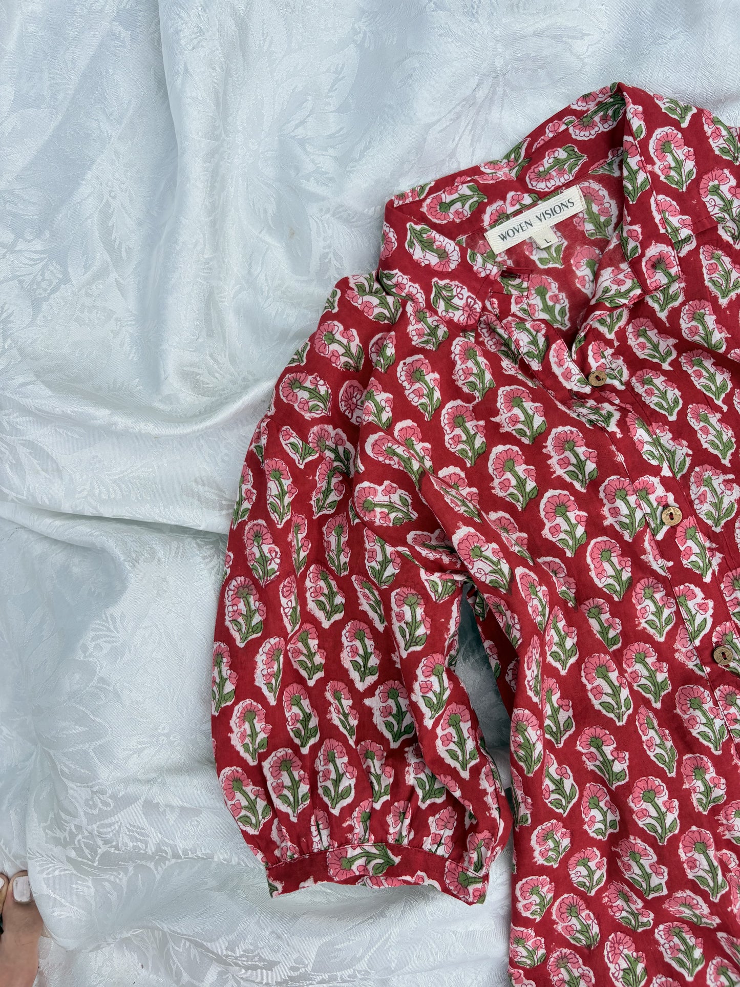 Close-up of button front detail on red cotton short dress