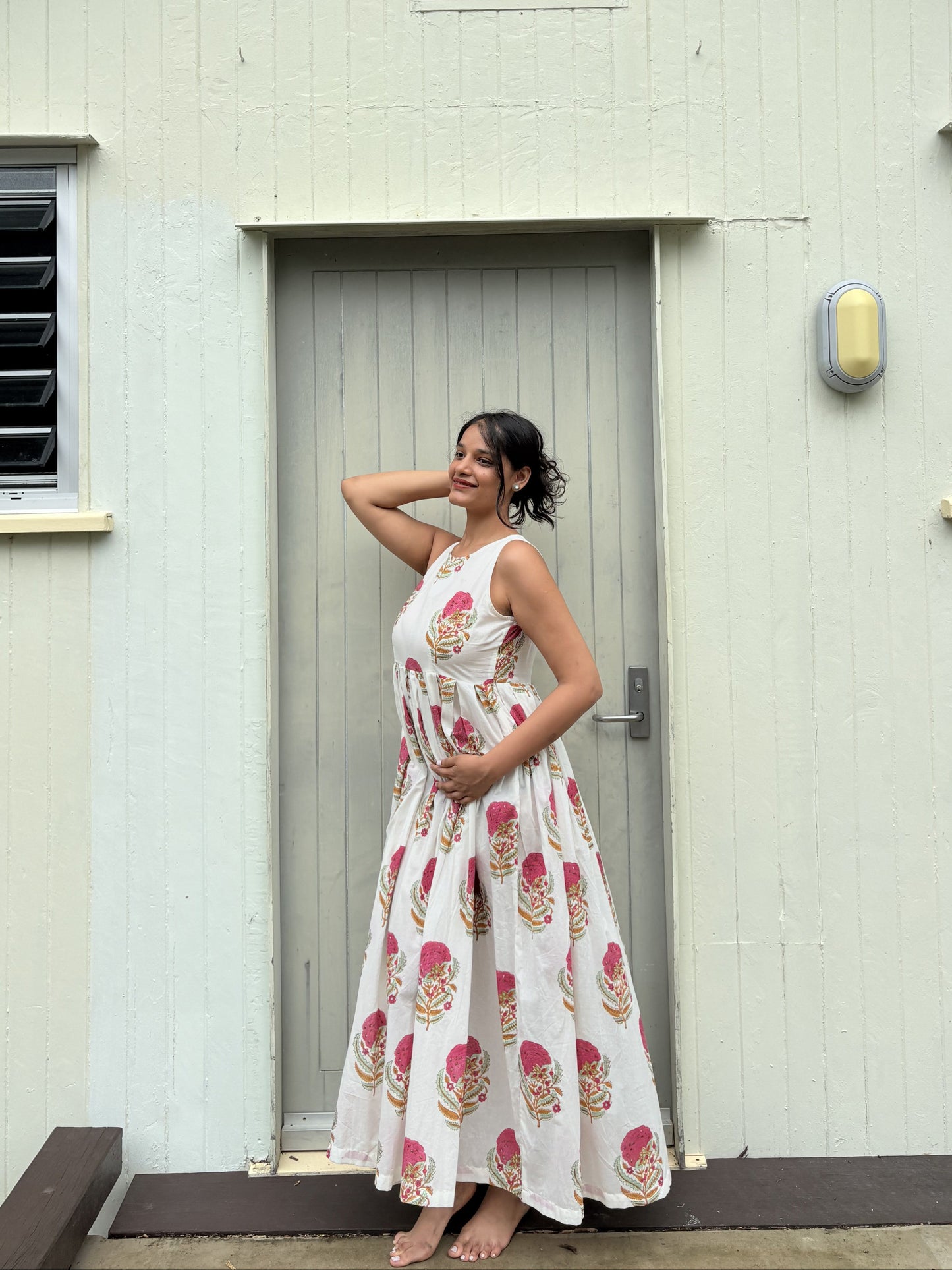 Detail of sleeveless halter neck design on pink floral dress