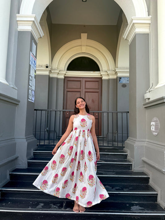 Woman wearing pink floral maxi dress with halter neck