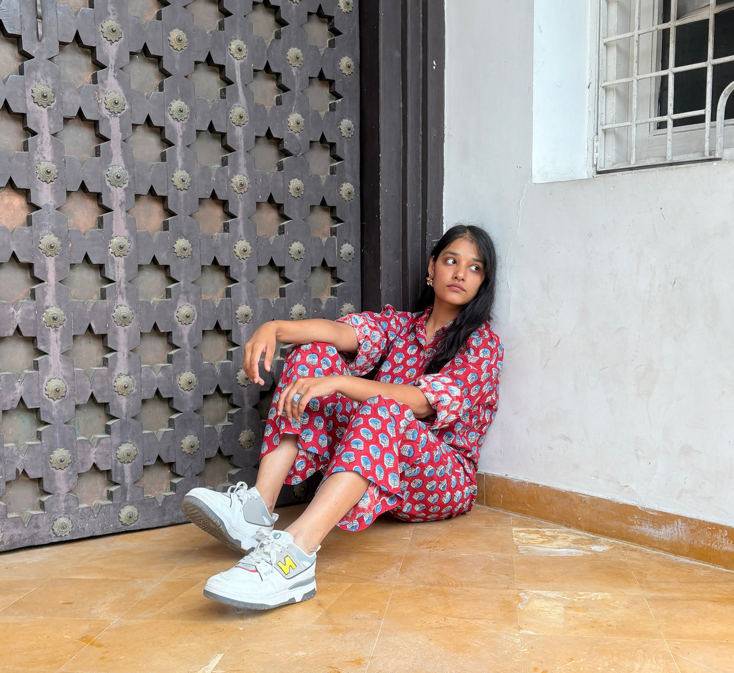 Woman wearing red Rakshita cotton co-ord set with blue floral hand block print
