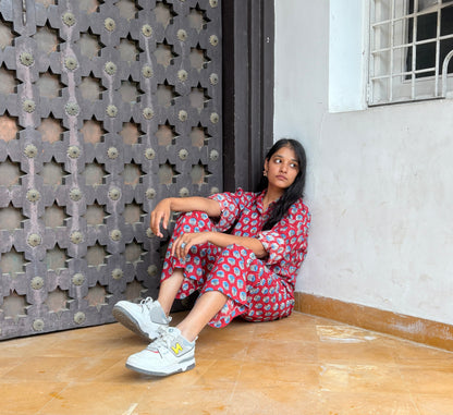Woman wearing red Rakshita cotton co-ord set with blue floral hand block print