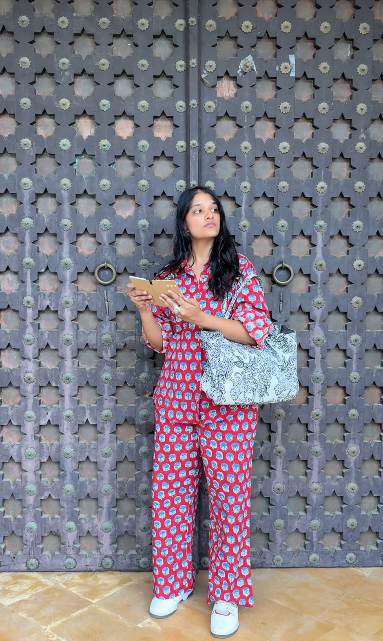 Woman wearing red Rakshita cotton co-ord set with blue floral hand block print 