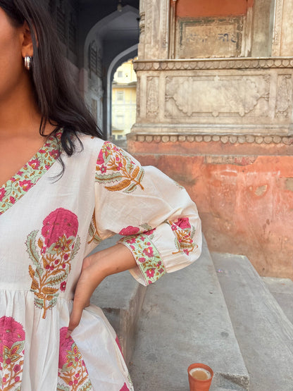 Close-up of hand block printed pink floral pattern on white cotton