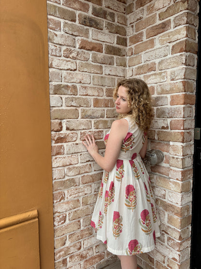 Woman wearing pink floral short dress with halter neck