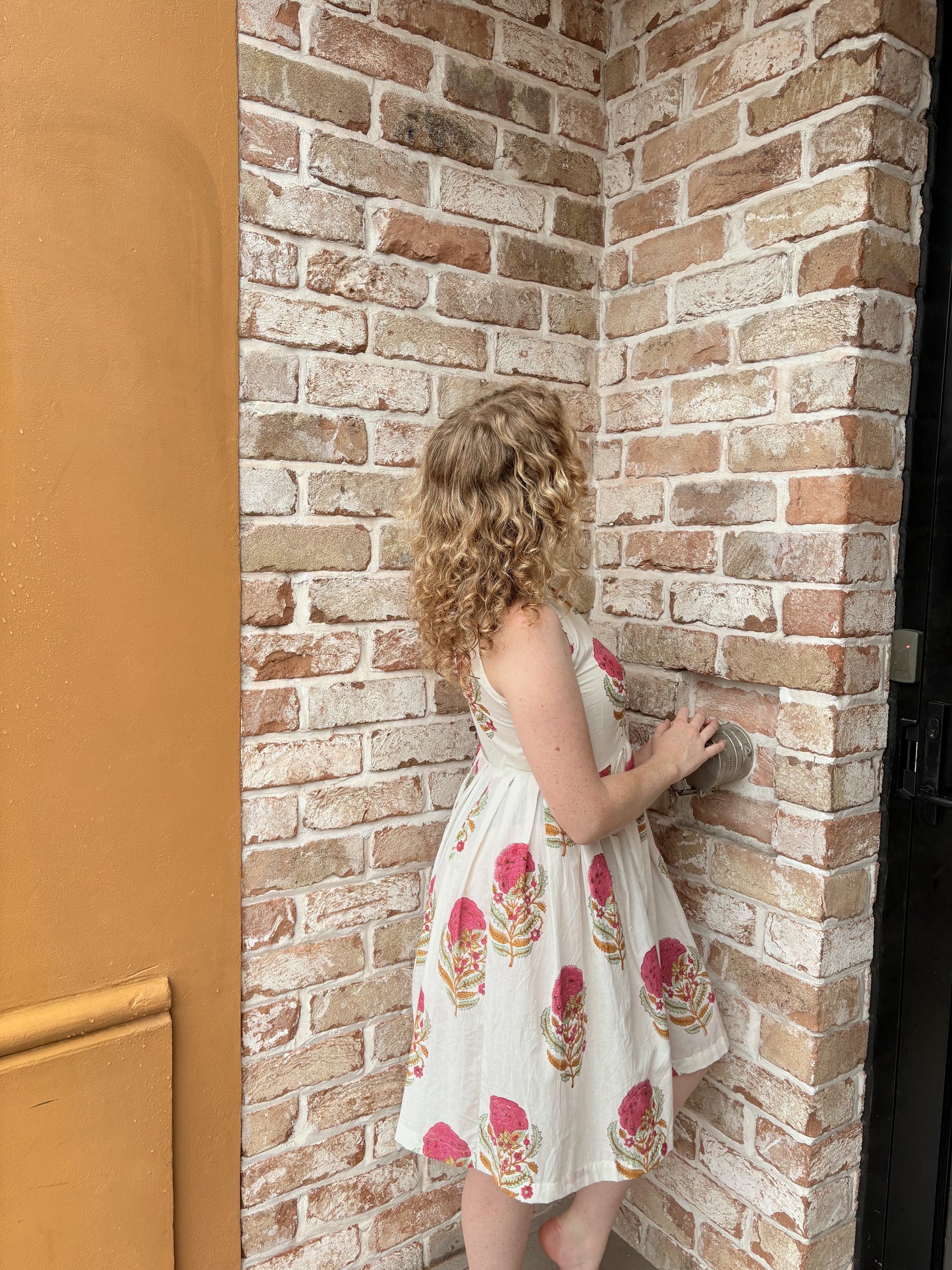 Detail of sleeveless halter design and playful floral pattern