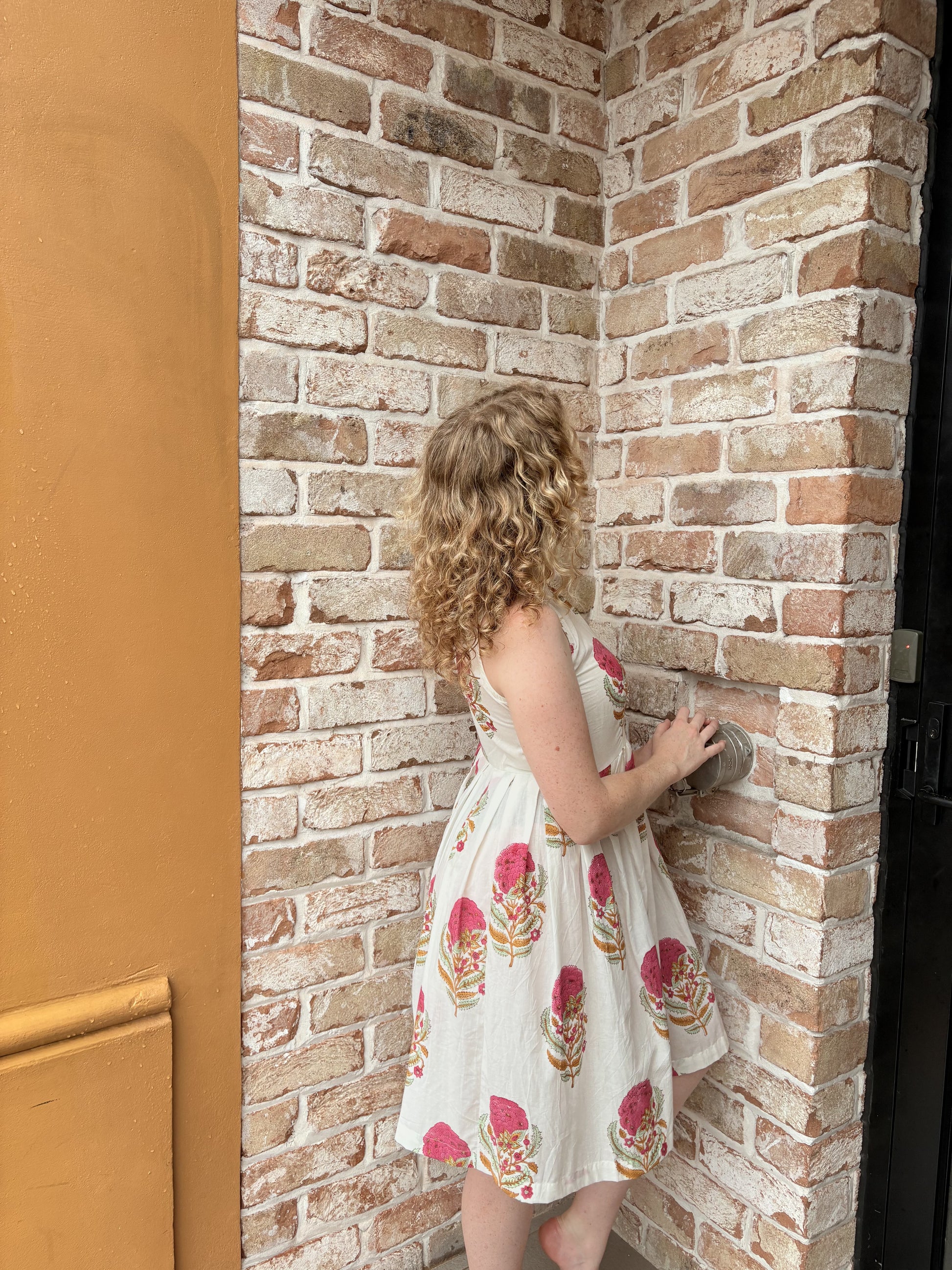 Detail of sleeveless halter design and playful floral pattern
