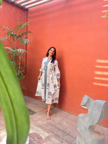 Woman wearing white midi dress with blue palm block print