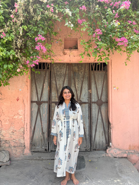 Woman wearing white midi dress with blue palm block print