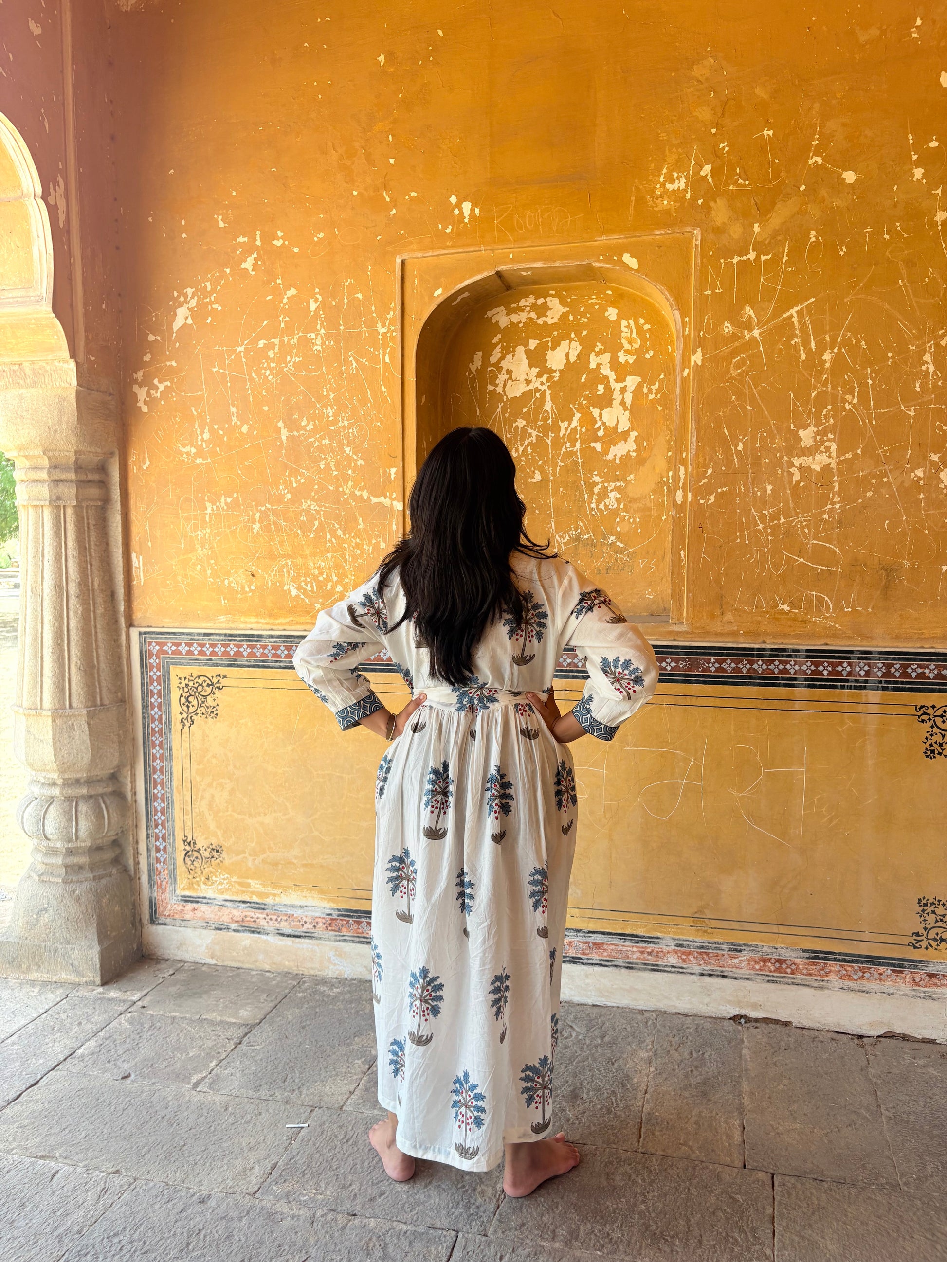 Palm Bay dress showing soft blue palm motifs on white cotton