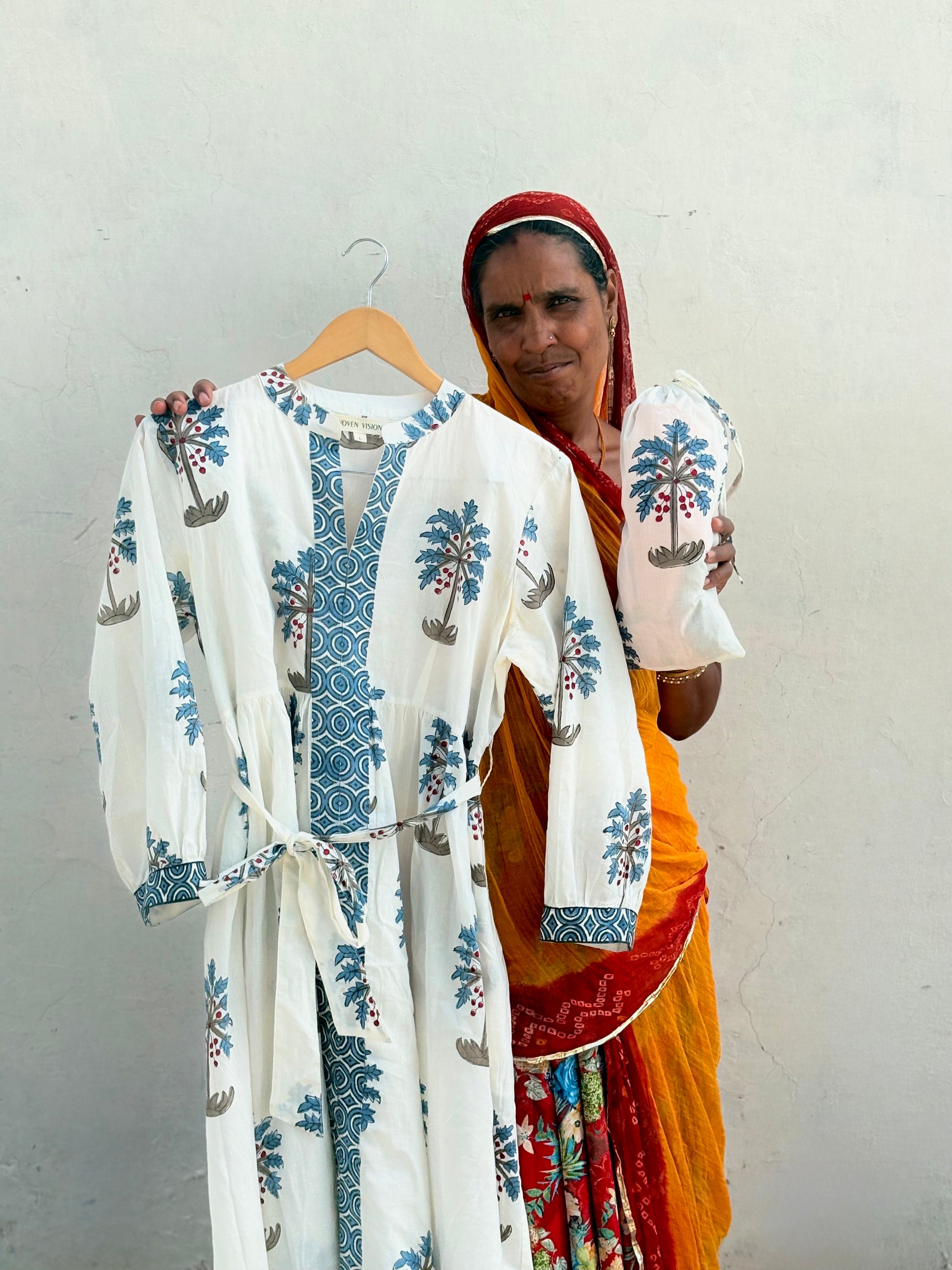 Close-up of hand-blocked blue palm pattern on white fabric with the artisan