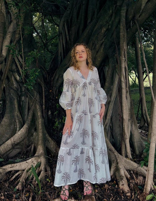 Woman wearing white maxi dress with grey palm block print