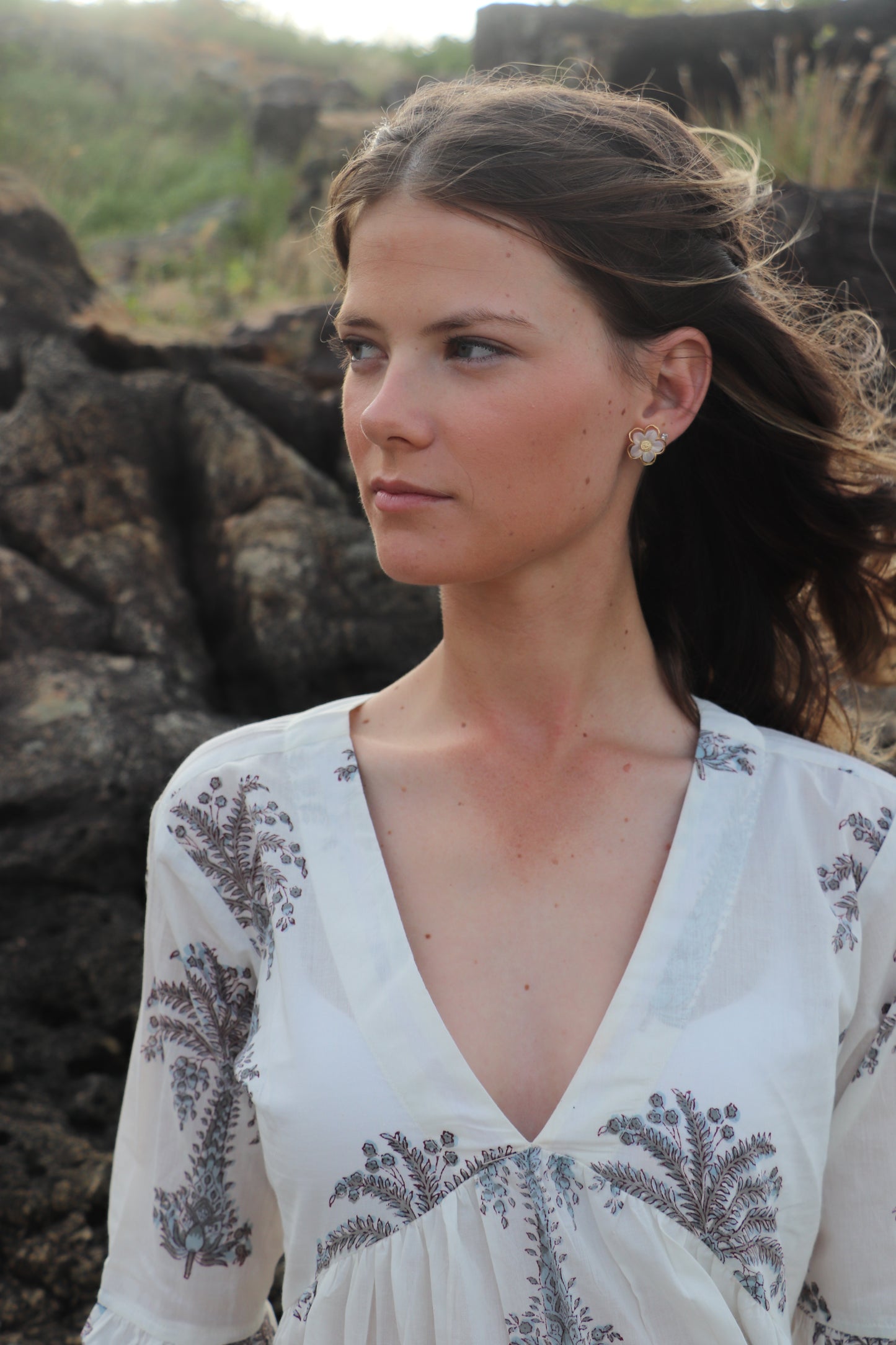 Close-up of grey palm print pattern on white maxi dress