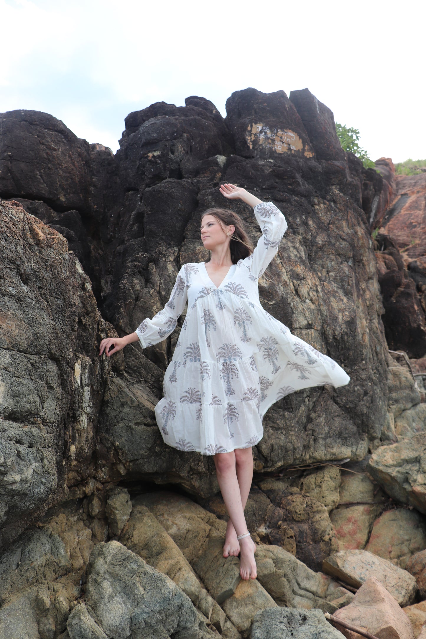 Woman wearing white short dress with grey palm block print