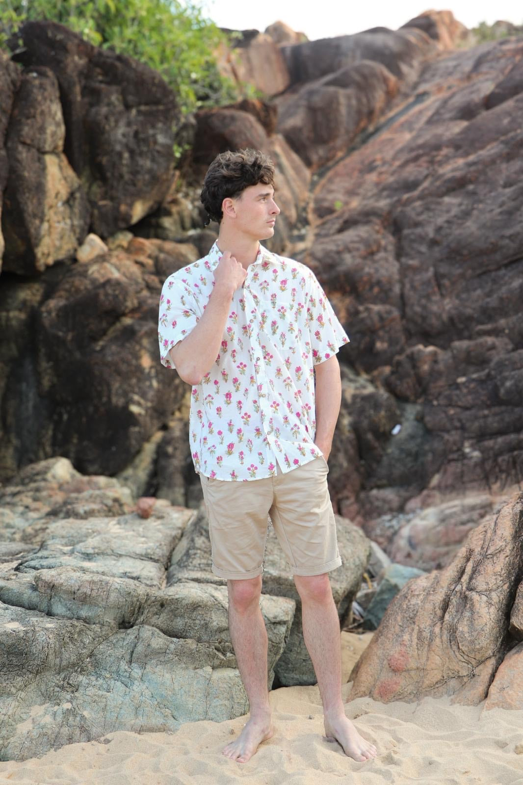 Person wearing white shirt with pink floral block print