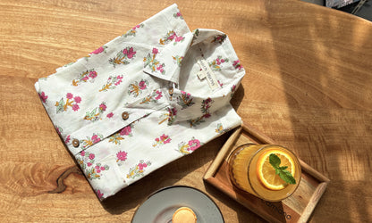 Close-up of hand-blocked pink floral pattern on white fabric