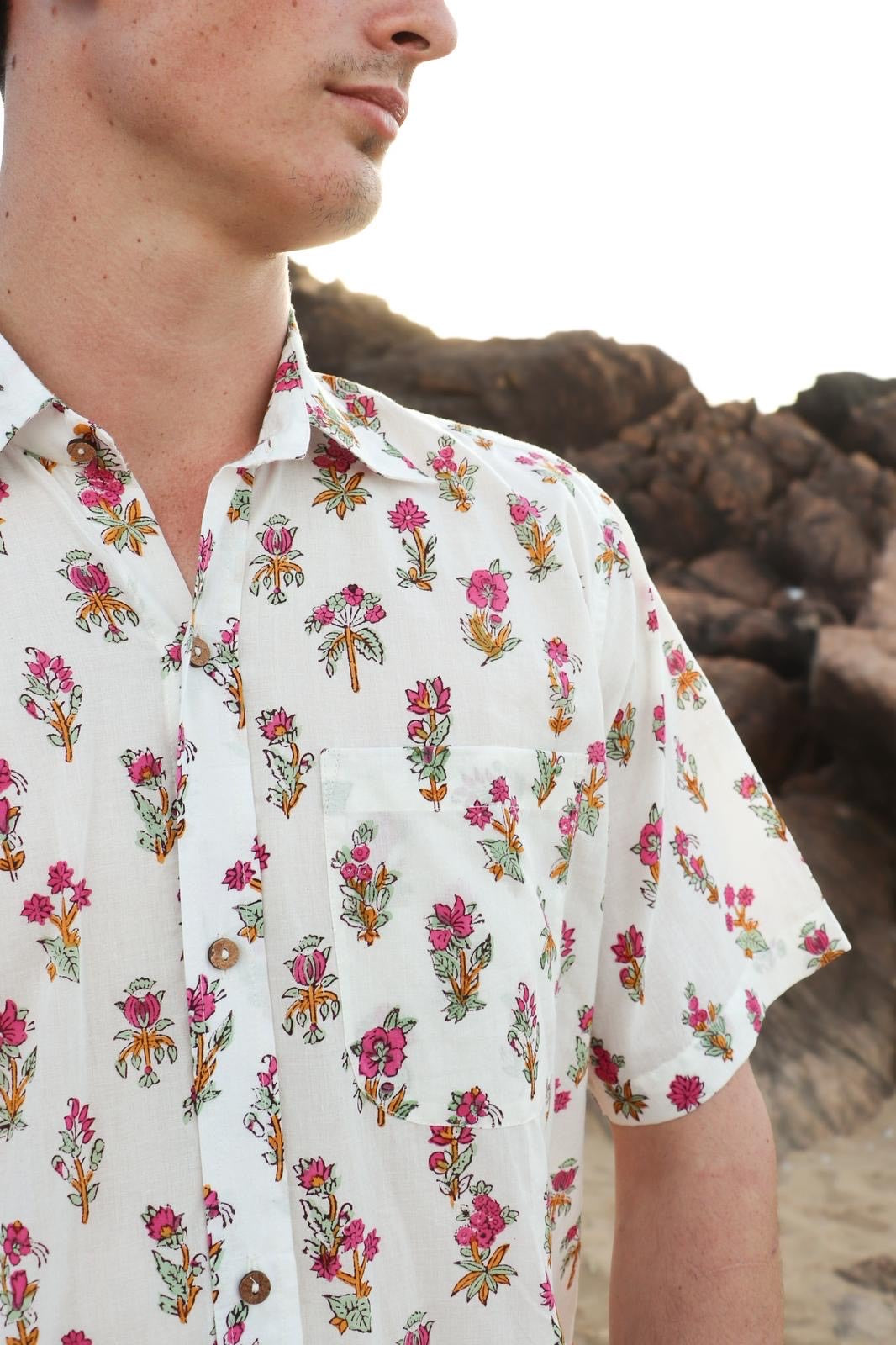 Close-up of hand-blocked pink floral pattern on white fabric