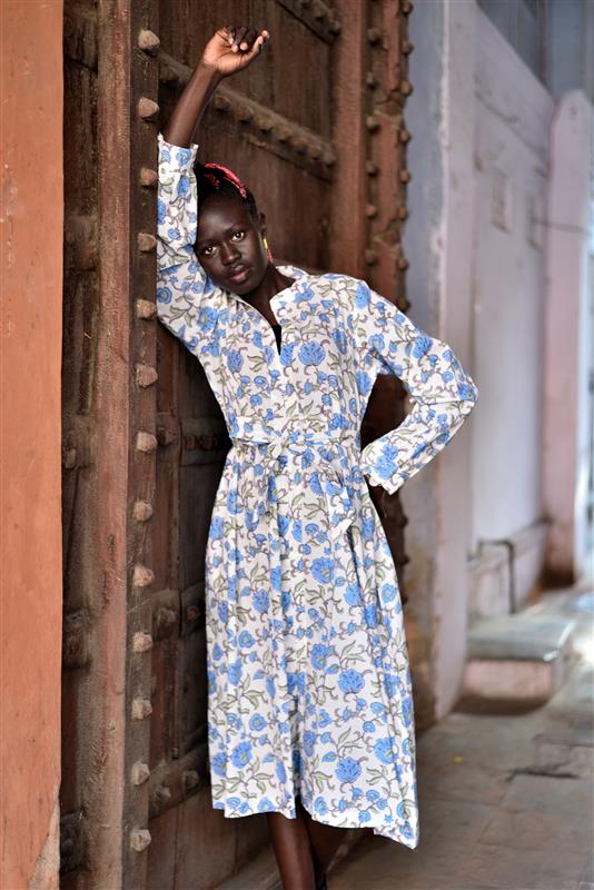 Woman wearing blue green midi dress with floral block print