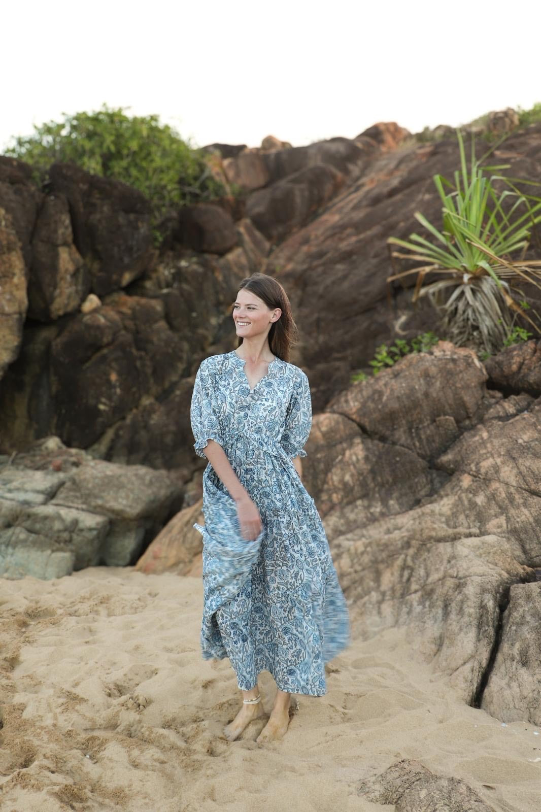 Full length view of sky blue tiered dress with flowy silhouette"