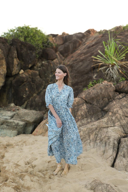 Full length view of sky blue tiered dress with flowy silhouette"