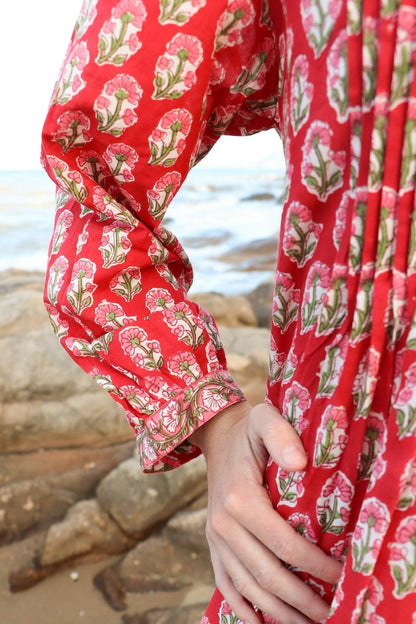 Sunset Muse red dress showing button front and pin-tuck details