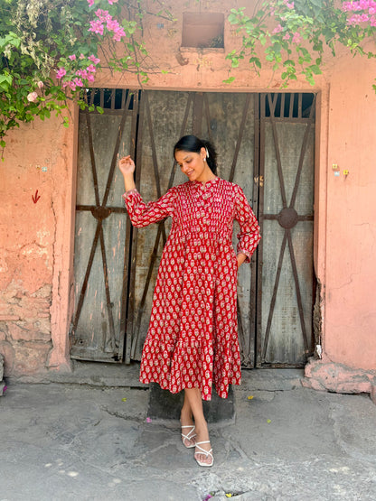 Detail of hidden pockets and flared hem on red maxi dress